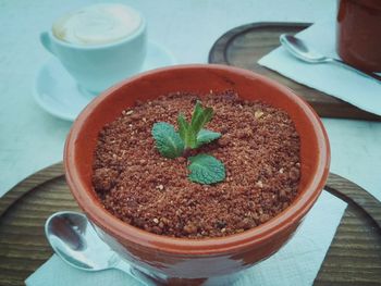 Close-up of coffee and potted plant on table