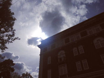 Low angle view of building against cloudy sky