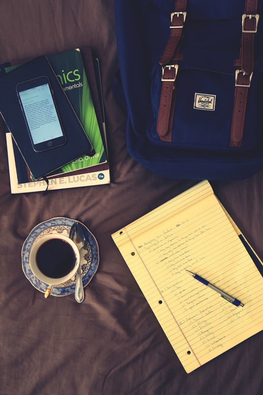 indoors, communication, table, person, technology, wireless technology, close-up, part of, high angle view, text, drink, holding, cropped, coffee cup, western script, leisure activity, smart phone