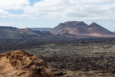 Scenic view of landscape and mountains against sky