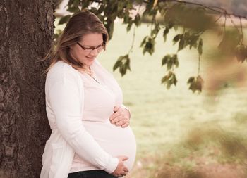Smiling young woman standing outdoors