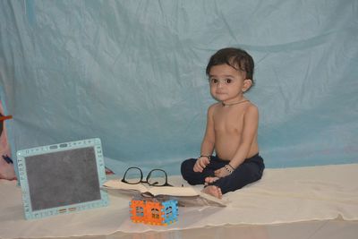 Portrait of shirtless boy sitting