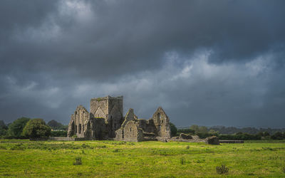 Old ruin on field against sky