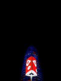 Low angle view of illuminated flag against black background