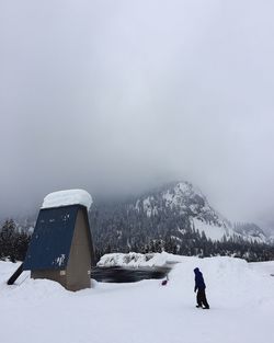 Person standing on snow covered landscape