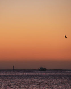 Scenic view of sea against orange sky