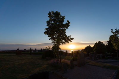 Scenic view of cemetery against clear sky during sunset