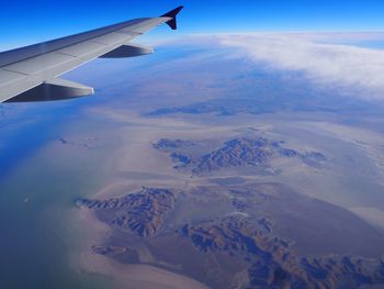 Aerial view of snowcapped mountains against sky