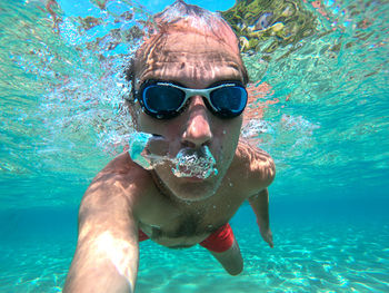 Portrait of man swimming in sea