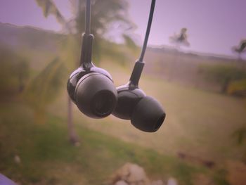 Close-up of airplane on field against sky