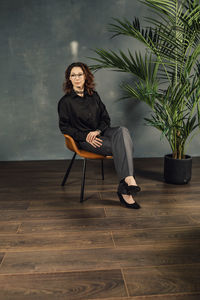 Business woman sitting cross-legged on a chair