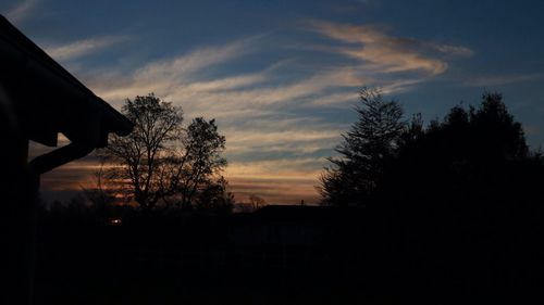 Silhouette of tree against cloudy sky