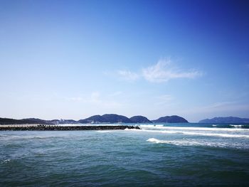 Scenic view of sea against blue sky