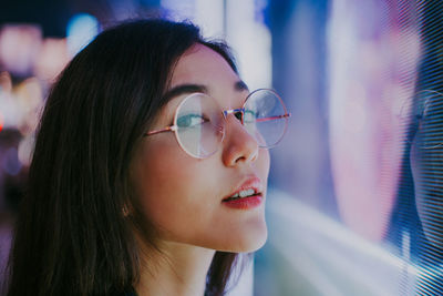 Close-up portrait of young woman looking away