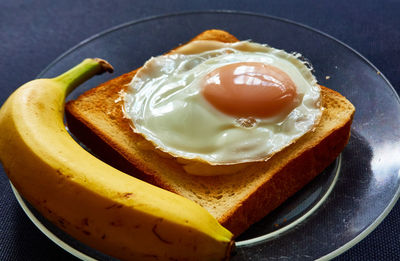 High angle view of bananas and a toast with egg on table