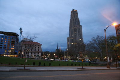 Illuminated buildings against sky at night