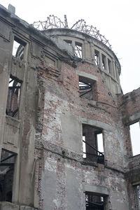 Low angle view of abandoned building against sky