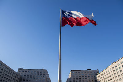 Chilean flag in the wind in front of government building in santiago