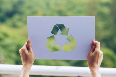 Close-up of hand holding paper