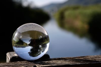 Close-up of crystal ball on glass