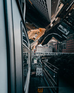 Aerial view of city buildings seen through train window