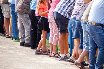 Low section of people walking on street