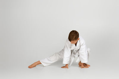 Rear view of woman standing against white background