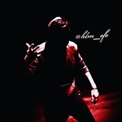 Man with fire hydrant against black background