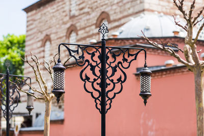 Low angle view of street light against building