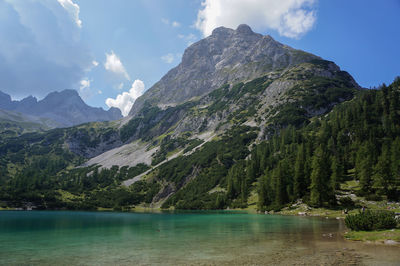 Scenic view of lake and mountains against sky