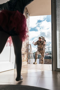 Full length of man standing in front of window