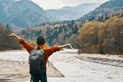 Rear view of man standing by mountain