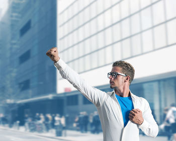 Full length of man wearing sunglasses standing against built structure