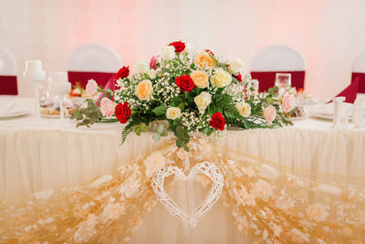 Flower vase on table against wall