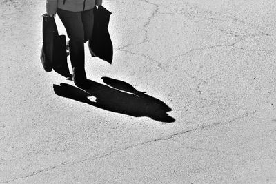 Low section of person walking on footpath