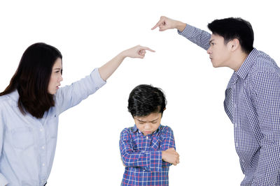 Friends standing against white background