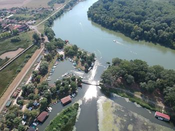 High angle view of river amidst trees in city