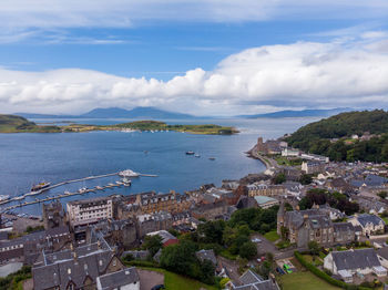 High angle view of townscape by sea against sky