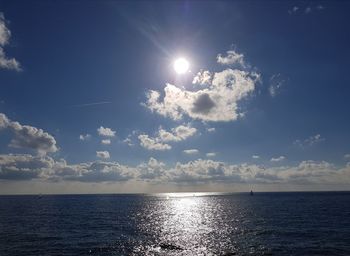 Scenic view of sea against bright sun