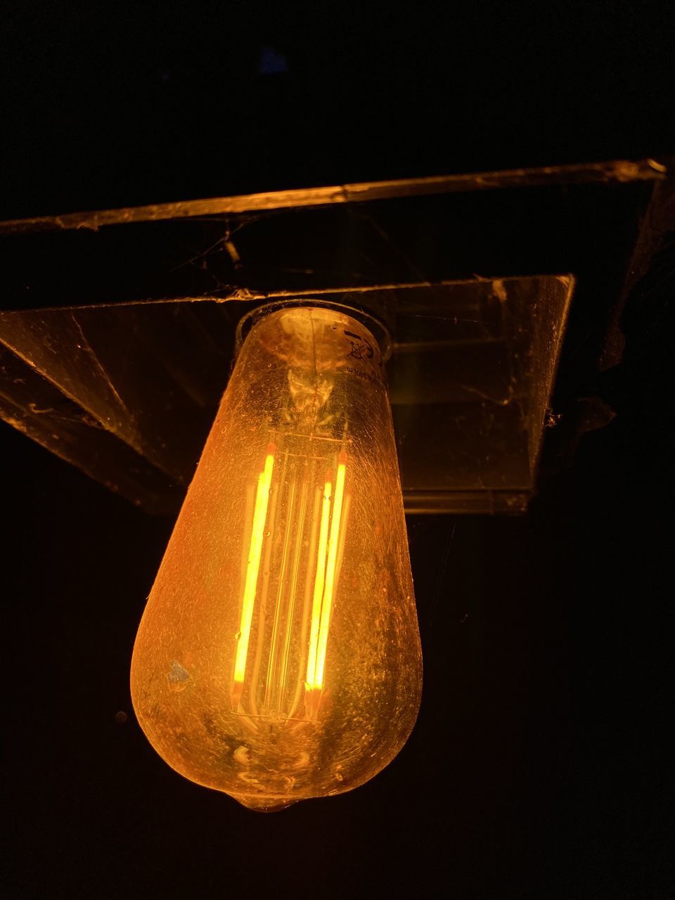 yellow, light, light fixture, lighting, light bulb, darkness, lighting equipment, night, illuminated, filament, electricity, no people, glowing, indoors, close-up, black background, incandescent light bulb, glass, studio shot, single object, technology, electric light, lamp, dark, light - natural phenomenon