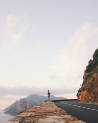 Rear view of person jogging on road