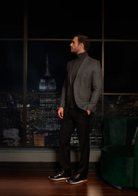 Side view of man standing in city