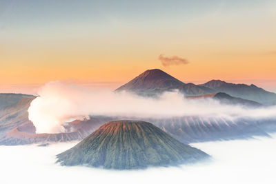 Scenic view of snowcapped mountains against sky during sunset