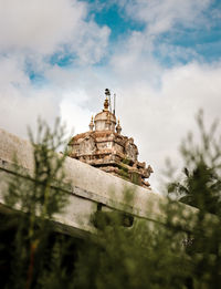 Low angle view of bell tower against sky