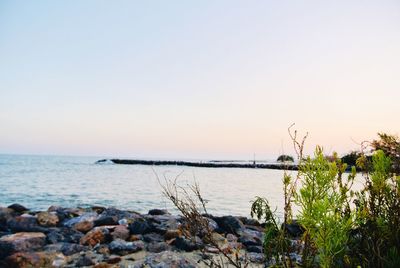 Scenic view of sea against clear sky during sunset