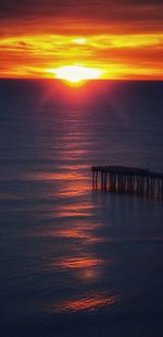 Scenic view of sea against orange sky