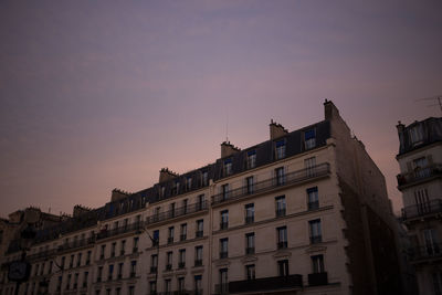 Low angle view of buildings against sky at sunset