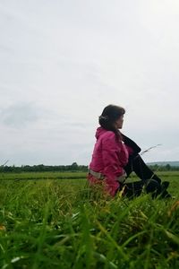 Rear view of man standing on grassy field