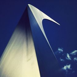 Low angle view of modern building against blue sky