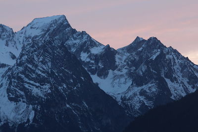 Scenic view of snowcapped mountains against sky during sunset